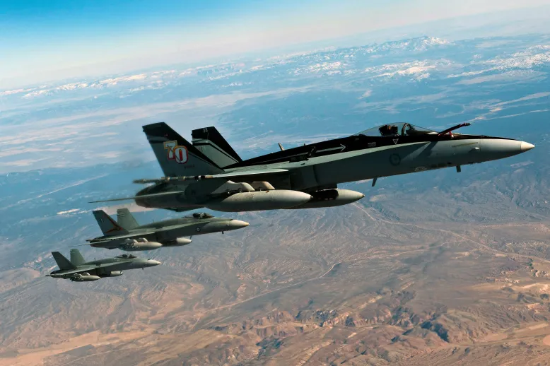 Three Department of Defence jets flying in formation.