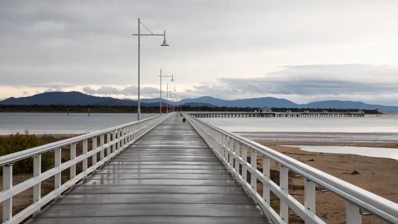 Vanishing perspective of an empty Wilsons Prom jetty on an overcast and wet day.