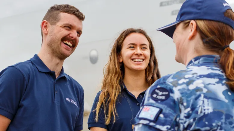 Two uniformed Bureau staff chat with a third uniformed Air Force staff member.