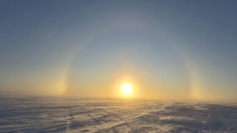 A rare phenomenon called a sun dog appears as a halo of light is projected in the sky