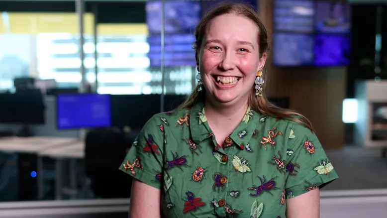 Erin Howard wears a green shirt and smiles