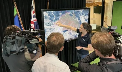 Meteorologist Jessica Lingard points at satellite image.