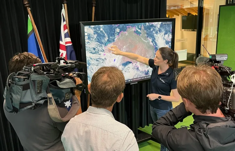 Jessica Lingard points at satellite image.