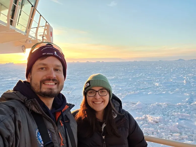 Bureau staff standing on a ship with ice and snow in the background.
