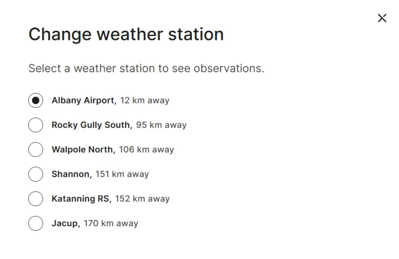 Screenshot of the 'Change weather station' pop-up box on the Albany, WA location page's Past tab. It shows the current weather station plus 5 alternative weather stations and how many kilometres away they are.